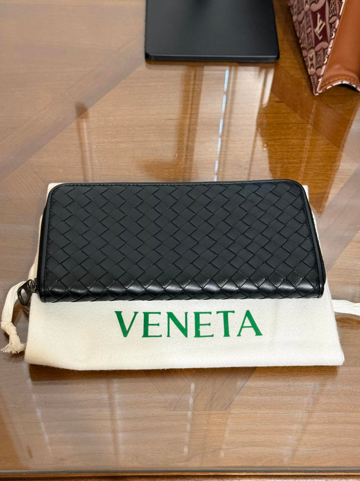 Bottega Veneta Intrecciato woven leather zip-around long wallet in black.