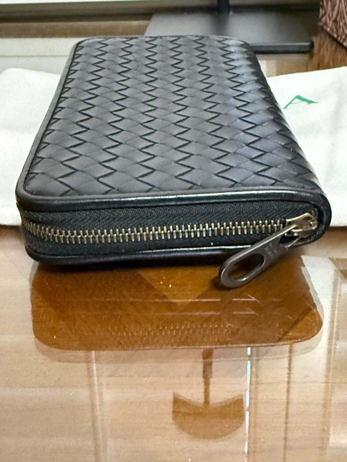 Bottega Veneta Intrecciato woven leather zip-around long wallet in black.