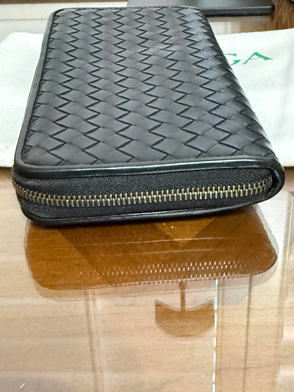 Bottega Veneta Intrecciato woven leather zip-around long wallet in black.