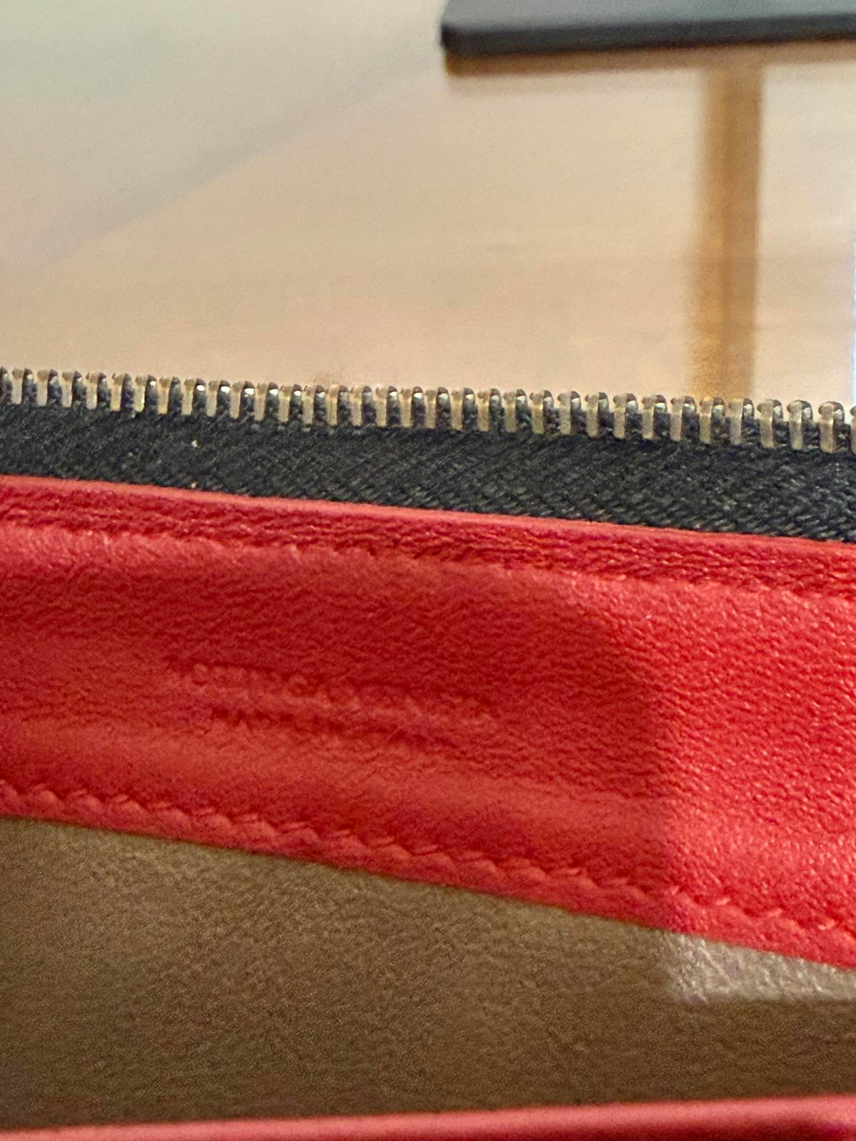 Bottega Veneta Intrecciato woven leather zip-around long wallet in black.