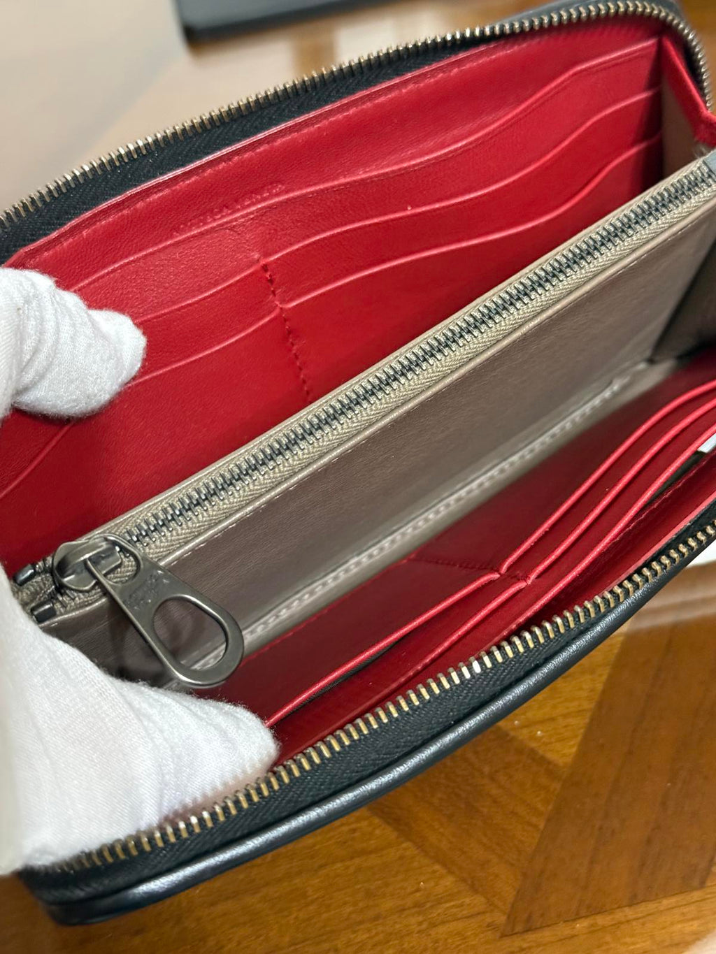 Bottega Veneta Intrecciato woven leather zip-around long wallet in black.